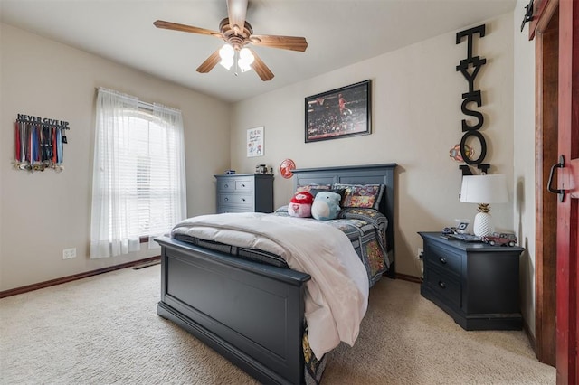 bedroom with light colored carpet, baseboards, and ceiling fan