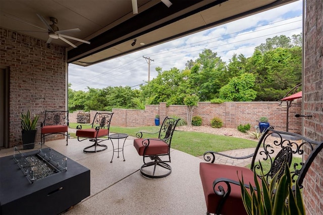 view of patio with a fire pit, a ceiling fan, and a fenced backyard