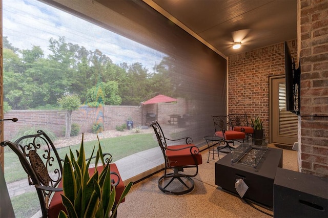view of patio featuring an outdoor fire pit and fence