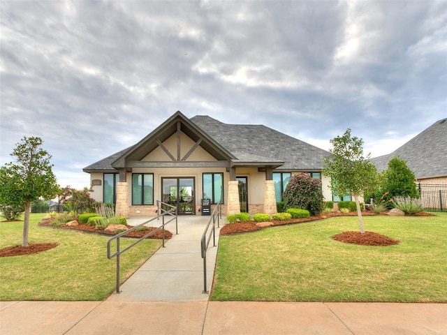 english style home featuring stucco siding and stone siding