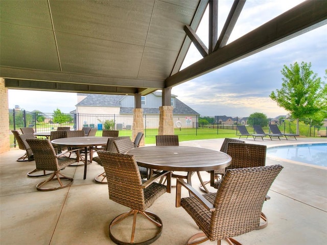 view of patio featuring outdoor dining space and a community pool