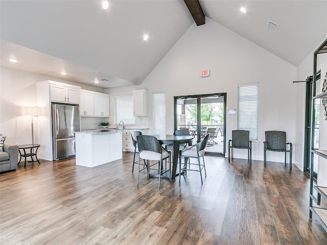 dining area featuring high vaulted ceiling, beam ceiling, dark wood finished floors, and recessed lighting