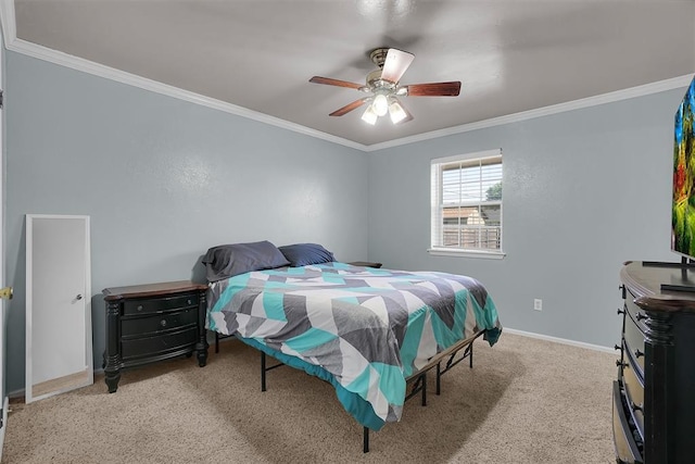 carpeted bedroom with ornamental molding, baseboards, and a ceiling fan