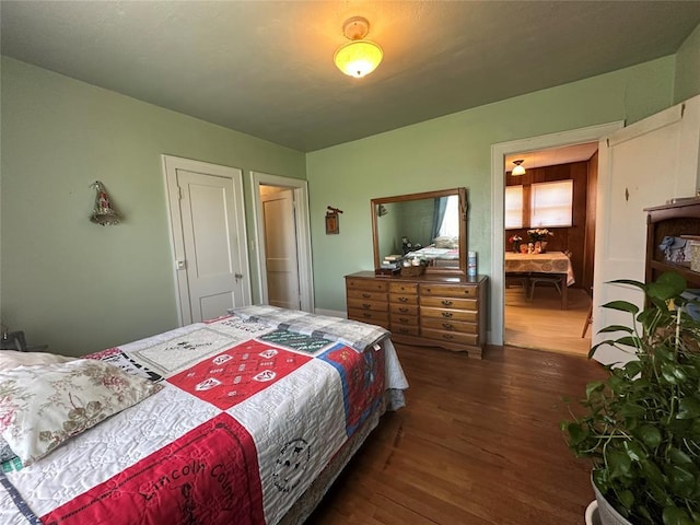 bedroom with dark wood-style floors