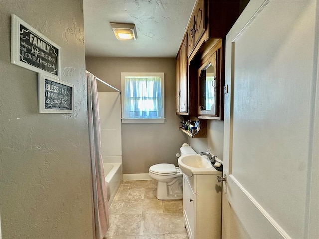 full bath featuring baseboards, toilet, vanity, and shower / tub combination