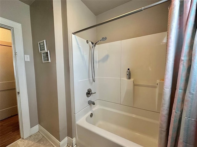 bathroom with baseboards, shower / bath combo, and tile patterned floors