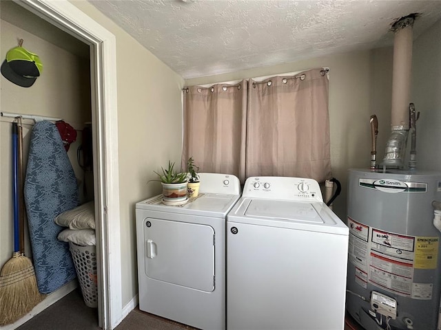 laundry area with water heater, washer and dryer, a textured ceiling, carpet floors, and baseboards