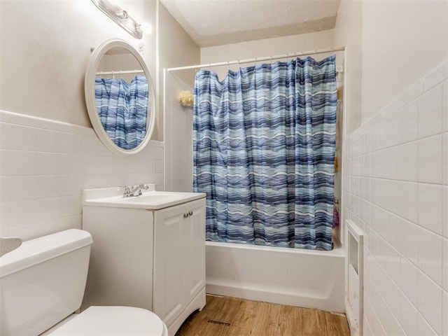 2210 SW 52nd St, Oklahoma City, OK 73119 - full bath featuring tile walls, shower / tub combo, wood finished floors, toilet, and vanity