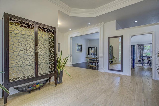 corridor featuring ornamental molding, wood finished floors, recessed lighting, ornate columns, and baseboards