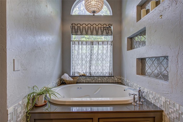 full bathroom with a bath and a textured wall
