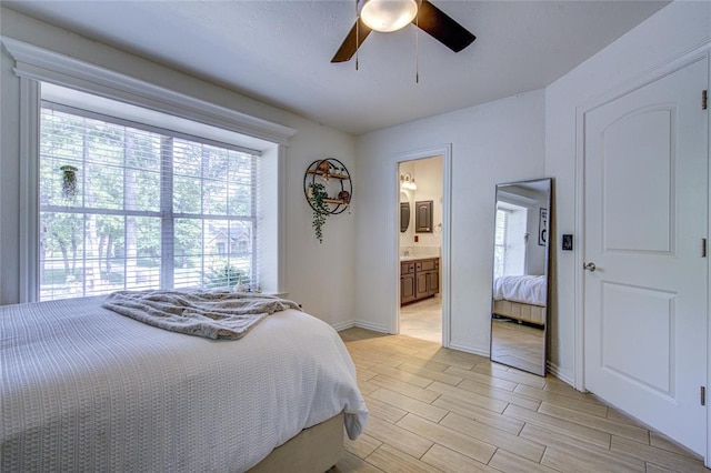 bedroom with multiple windows, light wood-type flooring, a ceiling fan, and baseboards