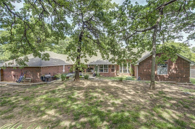 rear view of property featuring brick siding