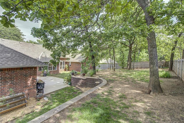 fenced backyard with a patio area