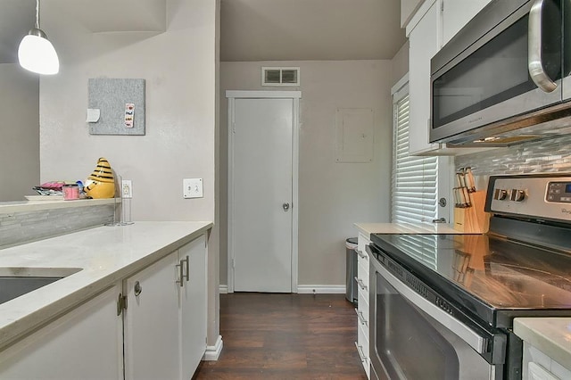 807 Cardinal Creek Blvd Unit C, Norman, OK 73072 - kitchen featuring stainless steel appliances, light countertops, backsplash, dark wood-type flooring, and white cabinetry