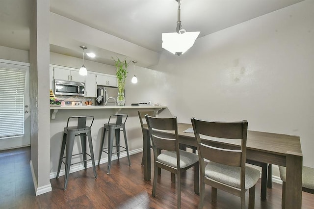 807 Cardinal Creek Blvd Unit C, Norman, OK 73072 - dining room featuring dark wood-style flooring and baseboards