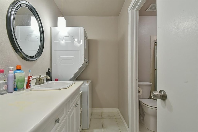 807 Cardinal Creek Blvd Unit C, Norman, OK 73072 - bathroom featuring stacked washer / dryer, toilet, baseboards, and vanity