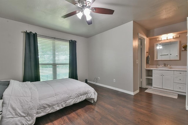807 Cardinal Creek Blvd Unit C, Norman, OK 73072 - bedroom with dark wood-style flooring, baseboards, a sink, ensuite bathroom, and a ceiling fan