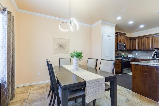 dining room featuring crown molding, baseboards, and recessed lighting