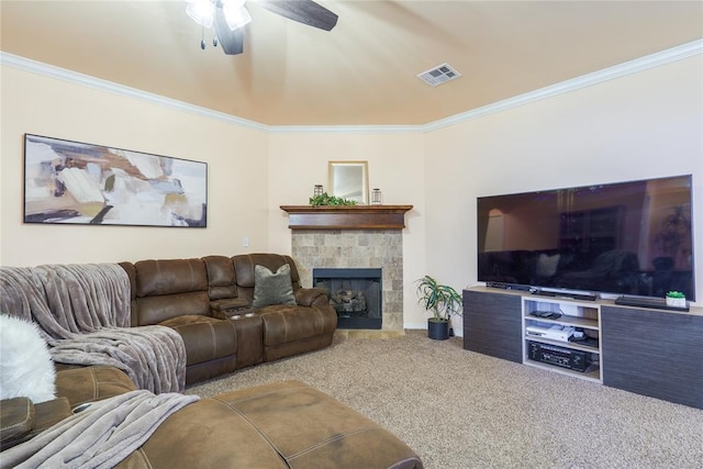 carpeted living area featuring crown molding, ceiling fan, a tile fireplace, and baseboards