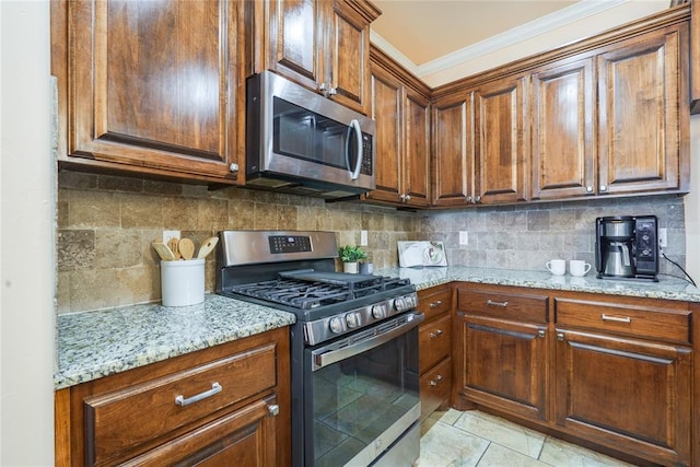 kitchen with stainless steel appliances, crown molding, light stone countertops, tasteful backsplash, and brown cabinets