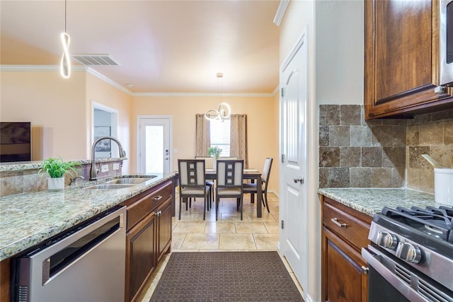 kitchen featuring dishwasher, a sink, backsplash, light stone counters, and ornamental molding
