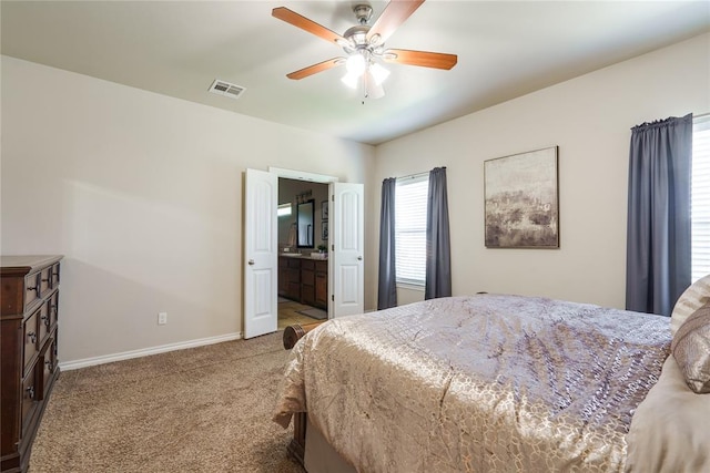 carpeted bedroom with baseboards, a ceiling fan, and ensuite bathroom