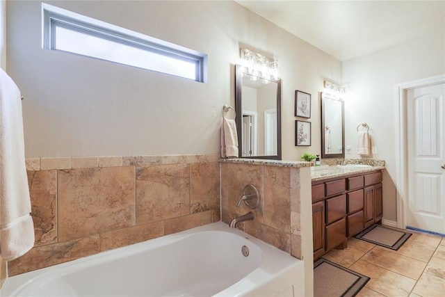 bathroom with healthy amount of natural light, a garden tub, and vanity
