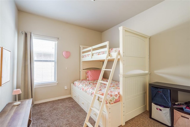 carpeted bedroom featuring multiple windows and baseboards