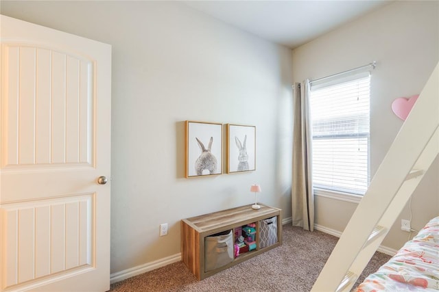 carpeted bedroom with multiple windows and baseboards