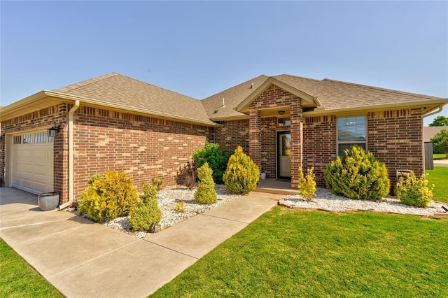 view of front facade featuring brick siding, a front yard, roof with shingles, and an attached garage