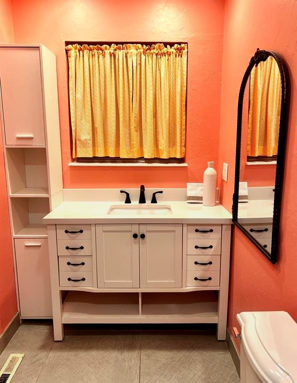 bathroom with vanity and toilet