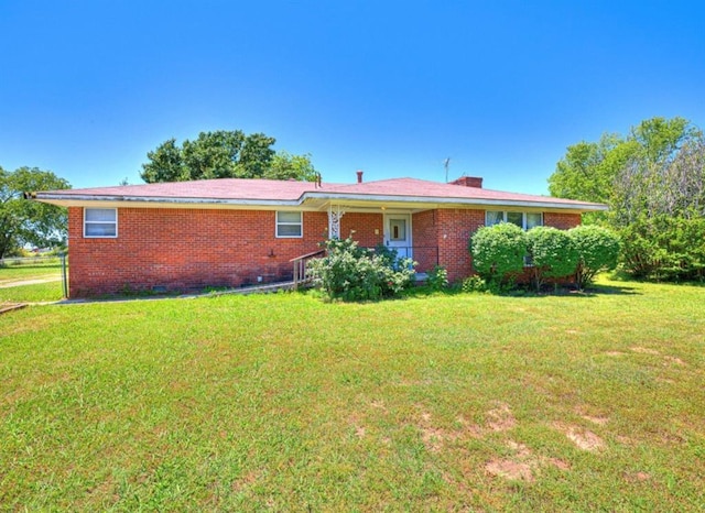 18906 13th St, Shawnee, OK 74801 - back of house with a lawn and brick siding