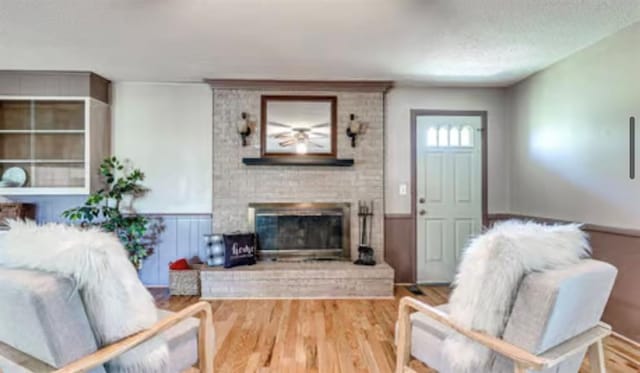 18906 13th St, Shawnee, OK 74801 - living area with a fireplace, wainscoting, and wood finished floors
