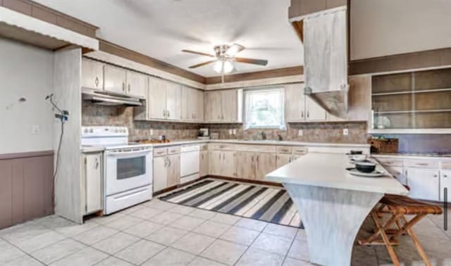 18906 13th St, Shawnee, OK 74801 - kitchen with white appliances, under cabinet range hood, ceiling fan, light countertops, and backsplash