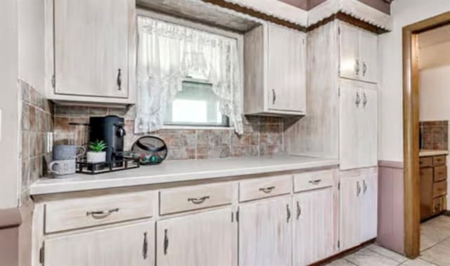18906 13th St, Shawnee, OK 74801 - kitchen featuring light countertops, tasteful backsplash, and light tile patterned floors