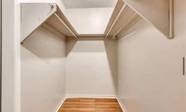 18906 13th St, Shawnee, OK 74801 - walk in closet featuring wood finished floors