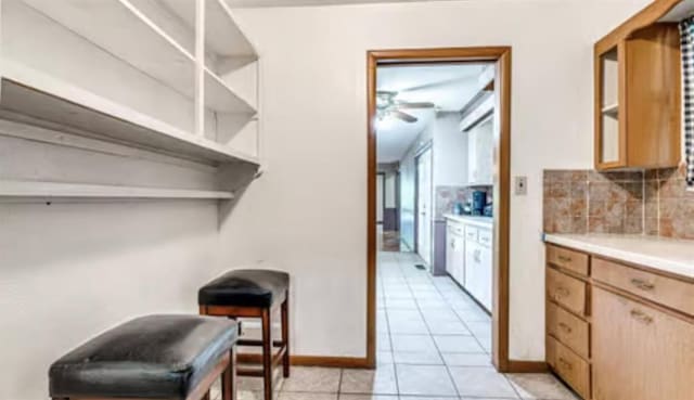 18906 13th St, Shawnee, OK 74801 - kitchen featuring decorative backsplash, light countertops, ceiling fan, open shelves, and light tile patterned floors