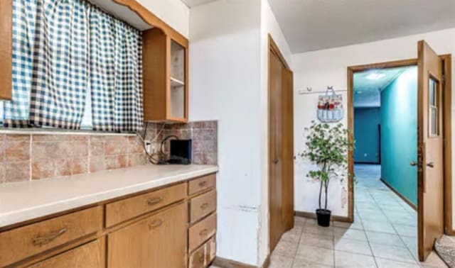18906 13th St, Shawnee, OK 74801 - kitchen featuring backsplash, light countertops, and light tile patterned floors