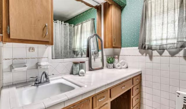 18906 13th St, Shawnee, OK 74801 - full bathroom with wallpapered walls, plenty of natural light, vanity, and tile walls