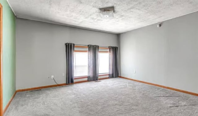 18906 13th St, Shawnee, OK 74801 - spare room featuring carpet floors, baseboards, and a textured ceiling