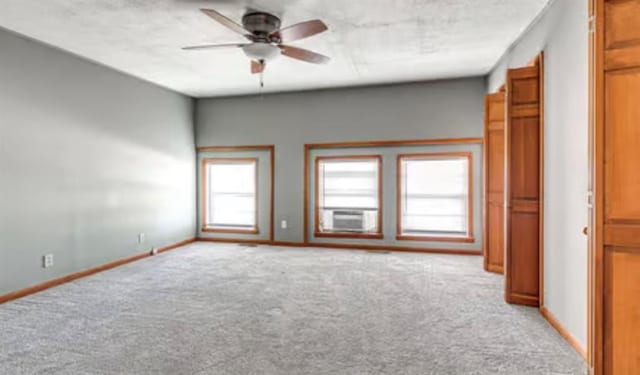 18906 13th St, Shawnee, OK 74801 - spare room featuring light carpet, a ceiling fan, baseboards, and cooling unit