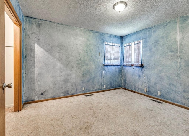 18906 13th St, Shawnee, OK 74801 - empty room featuring carpet flooring, a textured ceiling, and baseboards