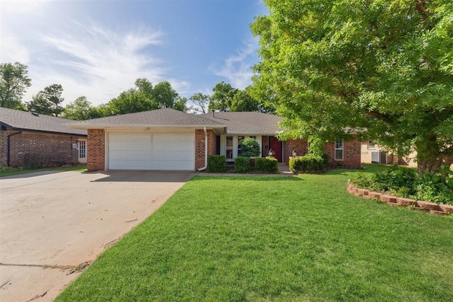 805 John F Kroutil Dr, Yukon, OK 73099 - single story home with a garage, concrete driveway, brick siding, and a front yard