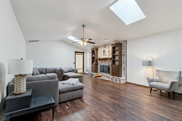 805 John F Kroutil Dr, Yukon, OK 73099 - living room featuring a skylight, a fireplace, wood finished floors, ceiling fan, and vaulted ceiling