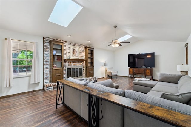 805 John F Kroutil Dr, Yukon, OK 73099 - living area featuring a skylight, dark wood finished floors, a brick fireplace, vaulted ceiling, and ceiling fan