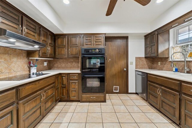 805 John F Kroutil Dr, Yukon, OK 73099 - kitchen with black appliances, a sink, under cabinet range hood, ceiling fan, and tasteful backsplash