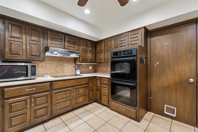 805 John F Kroutil Dr, Yukon, OK 73099 - kitchen featuring black appliances, under cabinet range hood, ceiling fan, light countertops, and light tile patterned floors
