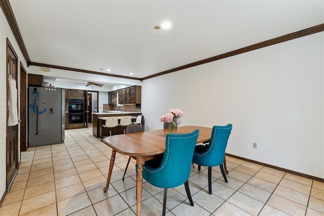 805 John F Kroutil Dr, Yukon, OK 73099 - dining space with crown molding, light tile patterned flooring, recessed lighting, ceiling fan, and baseboards