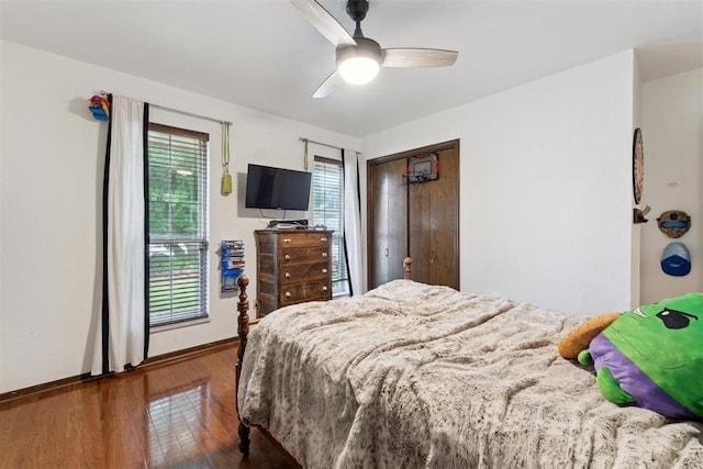 805 John F Kroutil Dr, Yukon, OK 73099 - bedroom with wood finished floors, baseboards, a closet, and a ceiling fan