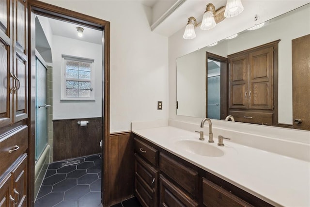 805 John F Kroutil Dr, Yukon, OK 73099 - full bath featuring wainscoting, vanity, tile patterned floors, and enclosed tub / shower combo